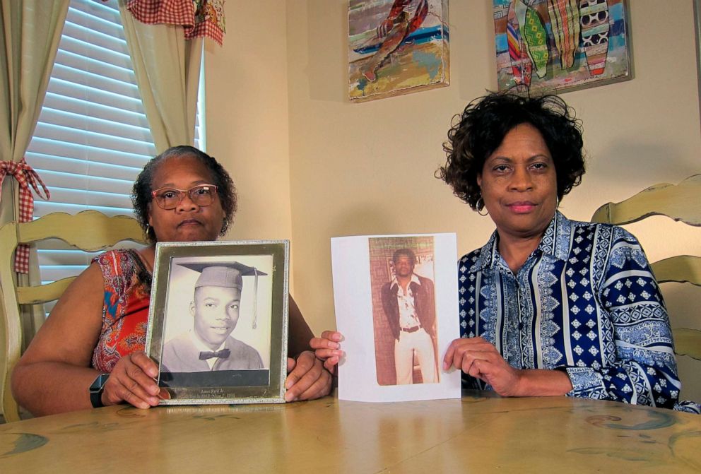 PHOTO: In this April 10, 2019, photo Mylinda Byrd Washington, 66, left, and Louvon Byrd Harris, 61, hold up photographs of their brother James Byrd Jr. in Houston.