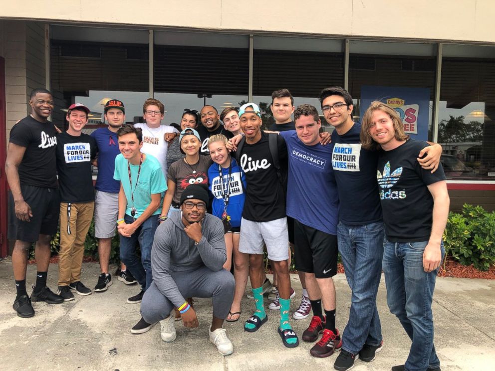 Waffle House shooting hero James Shaw Jr., far left, poses with survivors of the shooting at Marjory Stoneman Douglas High School in Parkland, Fla., on May 12, 2018.
