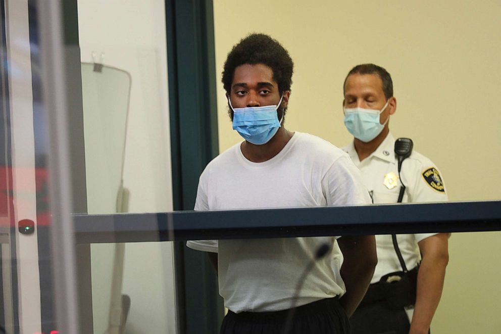 PHOTO: Jamhal Latimer, left, one of 11 people charged in connection with an armed standoff along a Massachusetts highway last weekend, appears during his arraignment at Malden District Court, July 6, 2021, in Medford, Mass. 