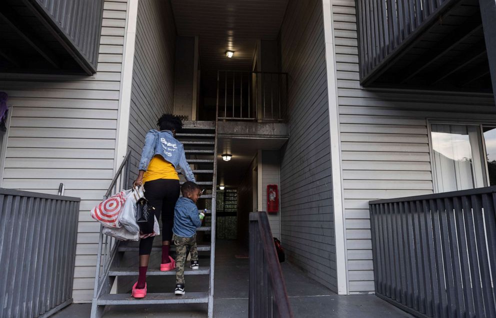 PHOTO: Jane Johnson walks her son to their second-story apartment after he got home from daycare, Oct. 27, 2021, in Birmingham, Ala. 