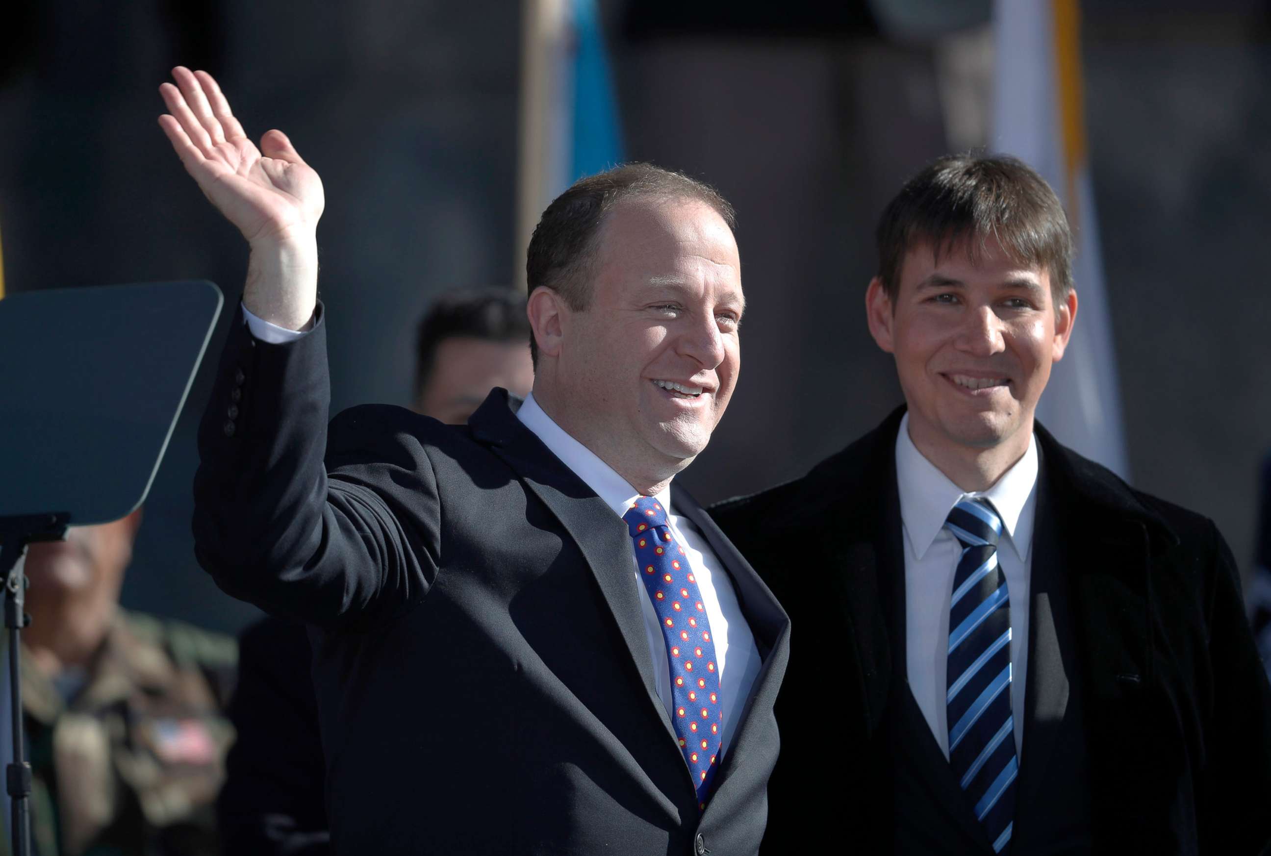 PHOTO: Colorado Gov. Jared Polis, left, joins his partner, Marlon Reis, in acknowledging the crowd after Polis took the oath of office during the inauguration ceremony o Jan. 8, 2019, in Denver.