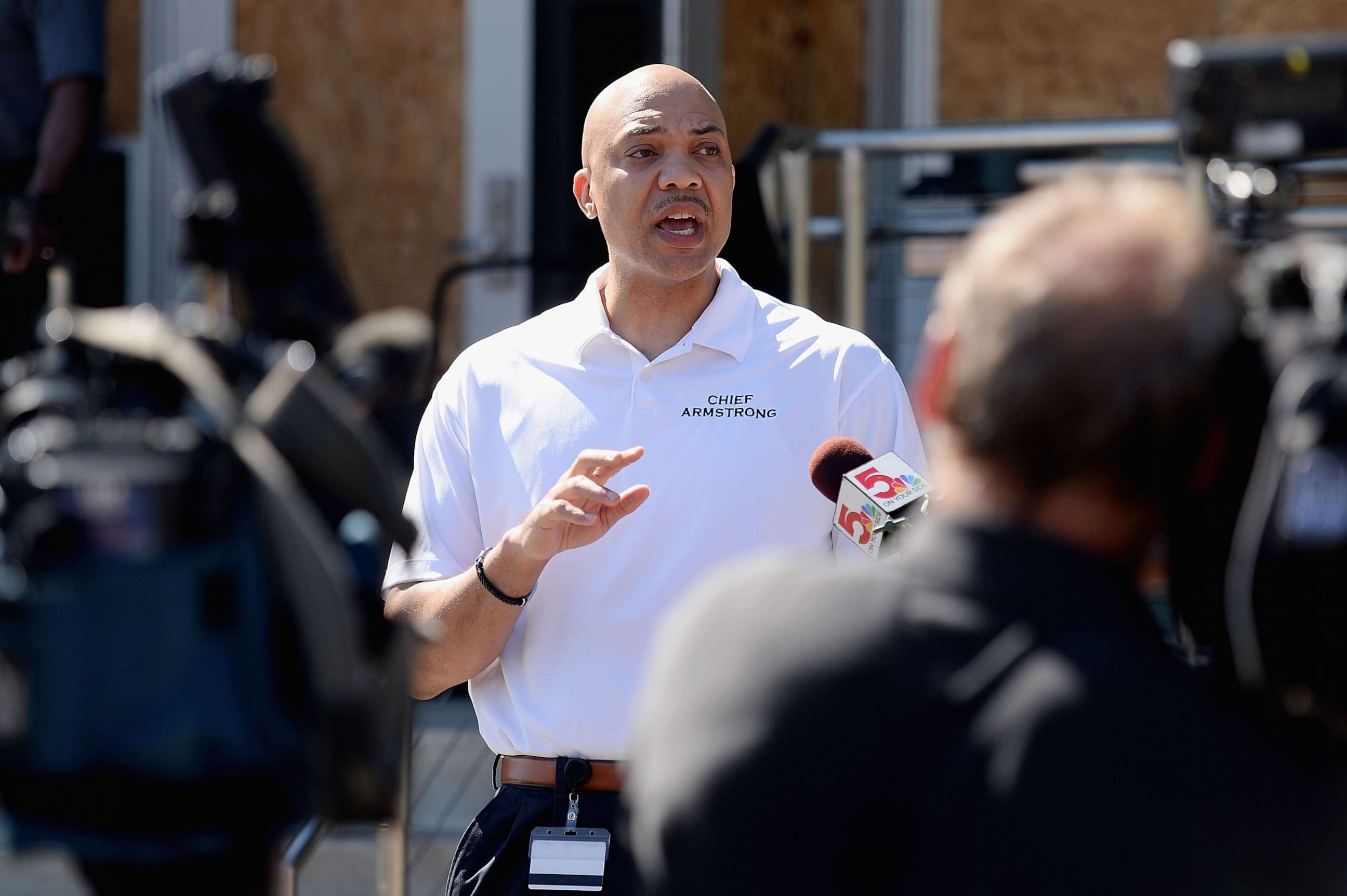 PHOTO: Ferguson Police Chief, Jason Armstrong speaks to media as volunteers help cleanup from an overnight clash between protesters and law enforcement at the Ferguson Police Department on May 31, 2020 in Ferguson, Missouri.