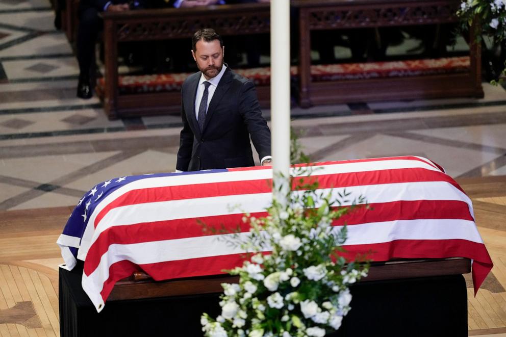 PHOTO: Grandson Jason Carter walks by and touches the flag-draped casket of former President Jimmy Carter, after speaking a tribute at the state funeral for Carter at Washington National Cathedral, Jan. 9, 2025, in Washington. 