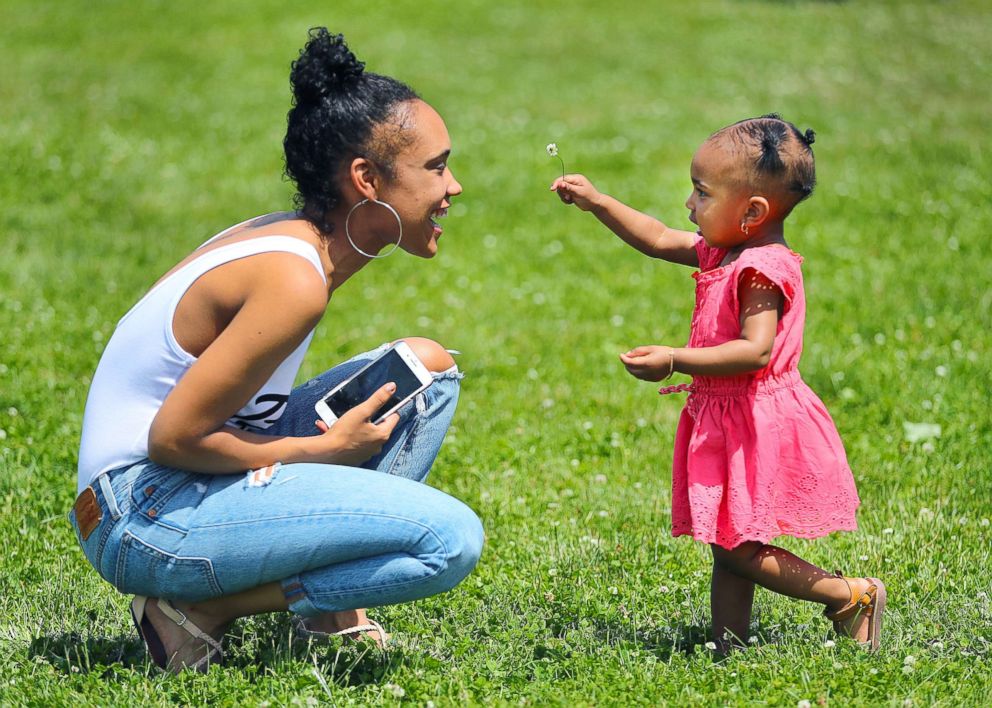 PHOTO: Jassy Correia plays with her 18-month-old daughter at Playstead Park in the Dorchester neighborhood of Boston on June 16, 2018.