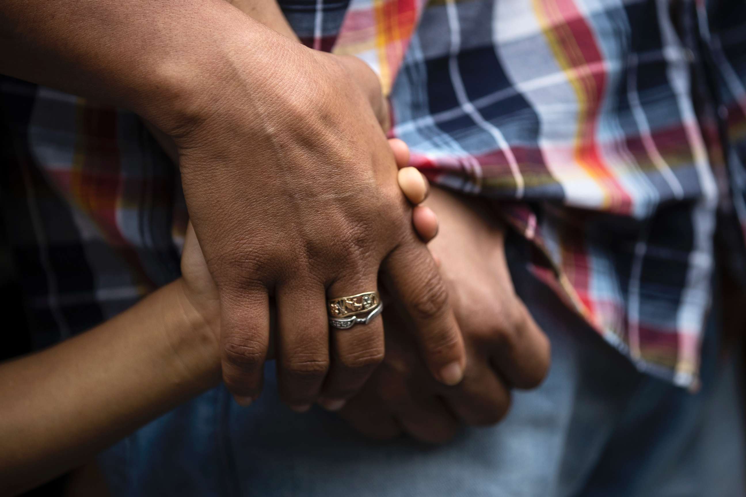 PHOTO: Alma Lopez holds her son Javier's and husband Javier Flores Garcia's hands during a news conference outside of the Arch Street United Methodist Church in Philadelphia, Oct. 11, 2017. 