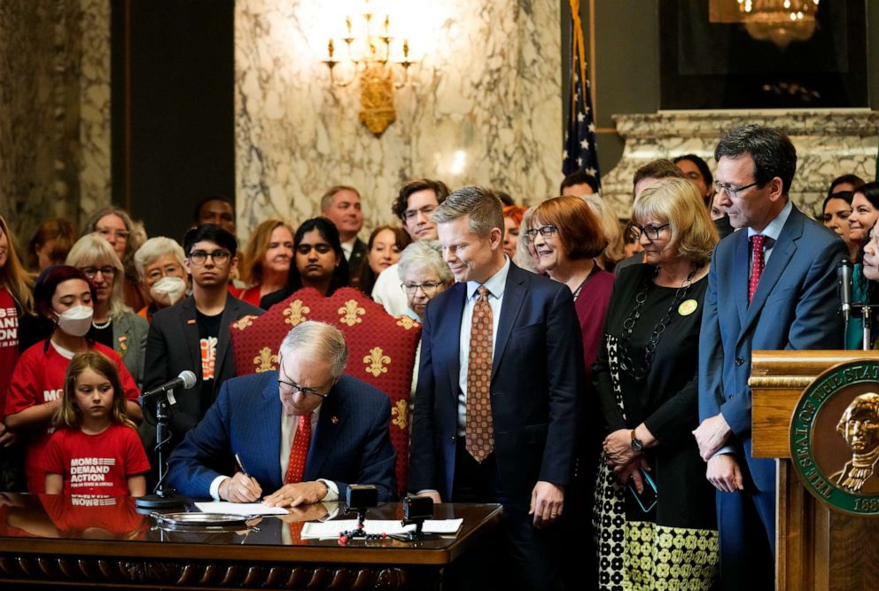 PHOTO: Washington Gov. Jay Inslee signs Senate Bill 5078, April 25, 2023, at the Capitol in Olympia, Wash.