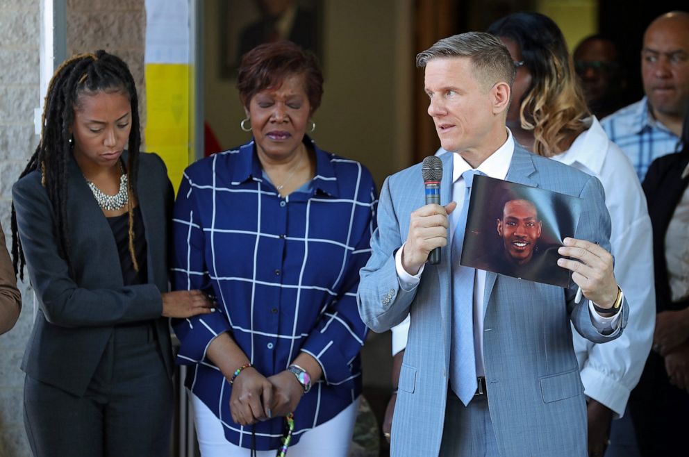PHOTO: Attorney Bobby DiCello, right, holds up a photograph of Jayland Walker as Paige White, left, comforts Jayland's mother Pamela Walker during a press conference at St. Ashworth Temple, June 30, 2022, in Akron, Ohio.
