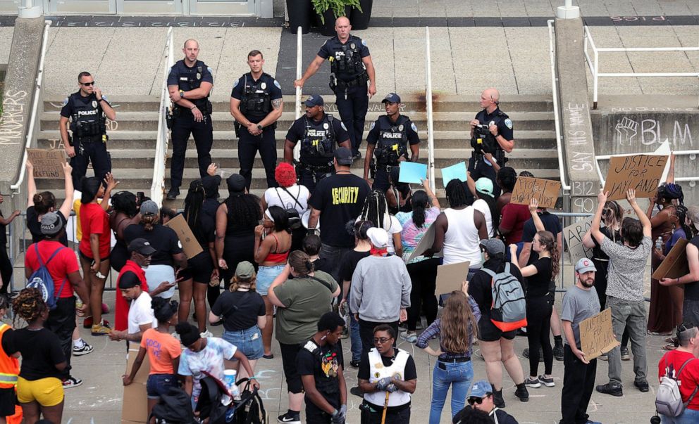 PHOTO: In this July 2, 2022, file photo, Akron police officers watch a group protesting the death of Jayland Walker outside the Harold K. Stubbs Justice Center, in Akron, Ohio.
