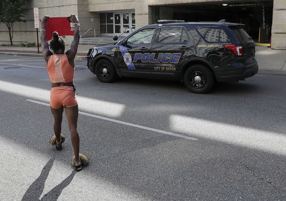 PHOTO: A protestor yells at a Police officer as he drives by the front of the Akron City Justice Center in Akron, Ohio, July 2, 2022.