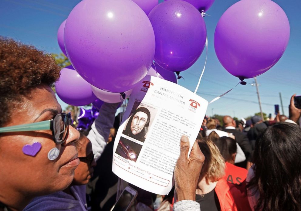 PHOTO: Donna Thomas holds a flyer about the shooting suspect as she attends a community rally for seven-year-old Jazmine Barnes in Houston, Jan. 5, 2019.