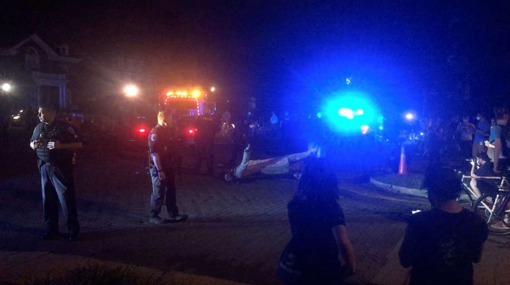 PHOTO: People gather around a statue of Confederate President Jefferson Davis defaced with paint after it was torn down in Richmond, Virginia, on June 10, 2020, in this screen grab from a social media video.