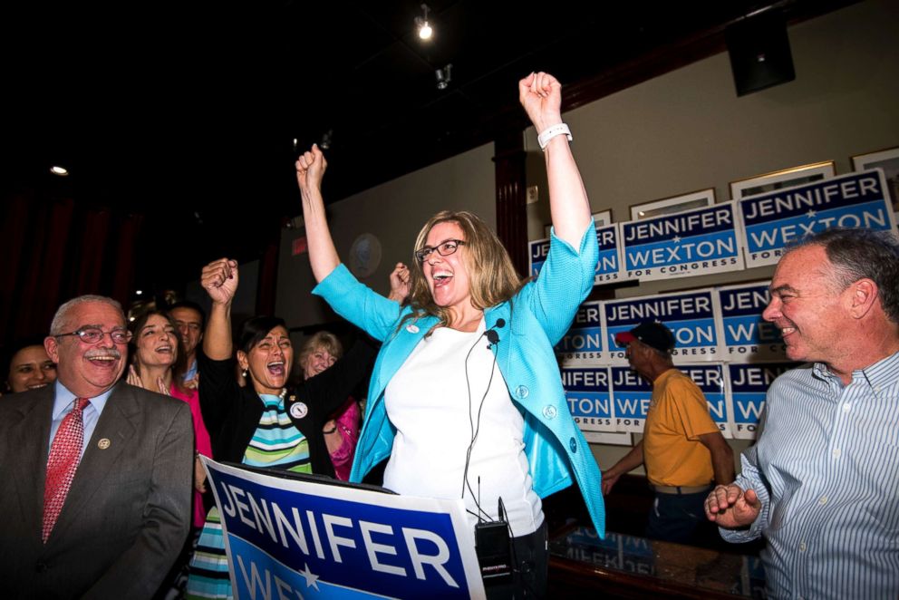 PHOTO: Jennifer Wexton, center, speaks flanked by Rep. Gerry Connolly, left, and Sen. Tim Kaine, at her primary election night party in Sterling, Va., on June 12, 2018.