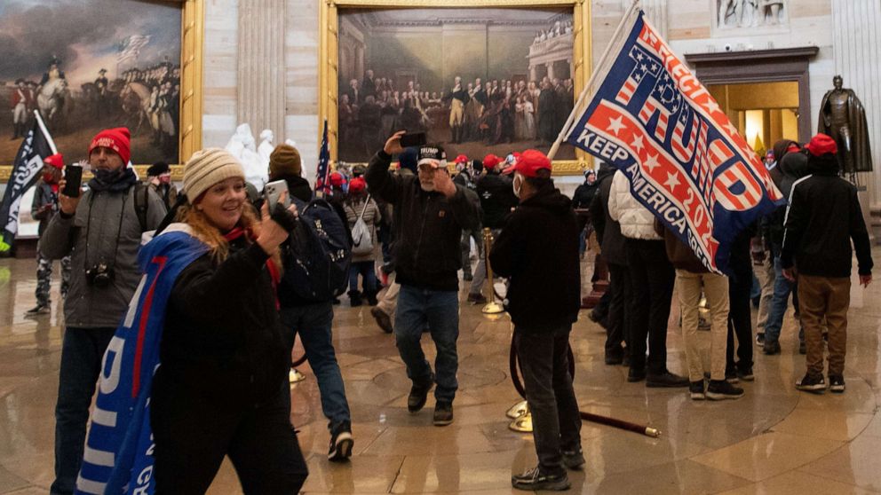 PHOTO: A woman identified by the FBI as Jenny Cudd, along with other supporters of President Donald Trump enters the US Capitol's Rotunda on Jan. 6, 2021, in Washington, D.C.