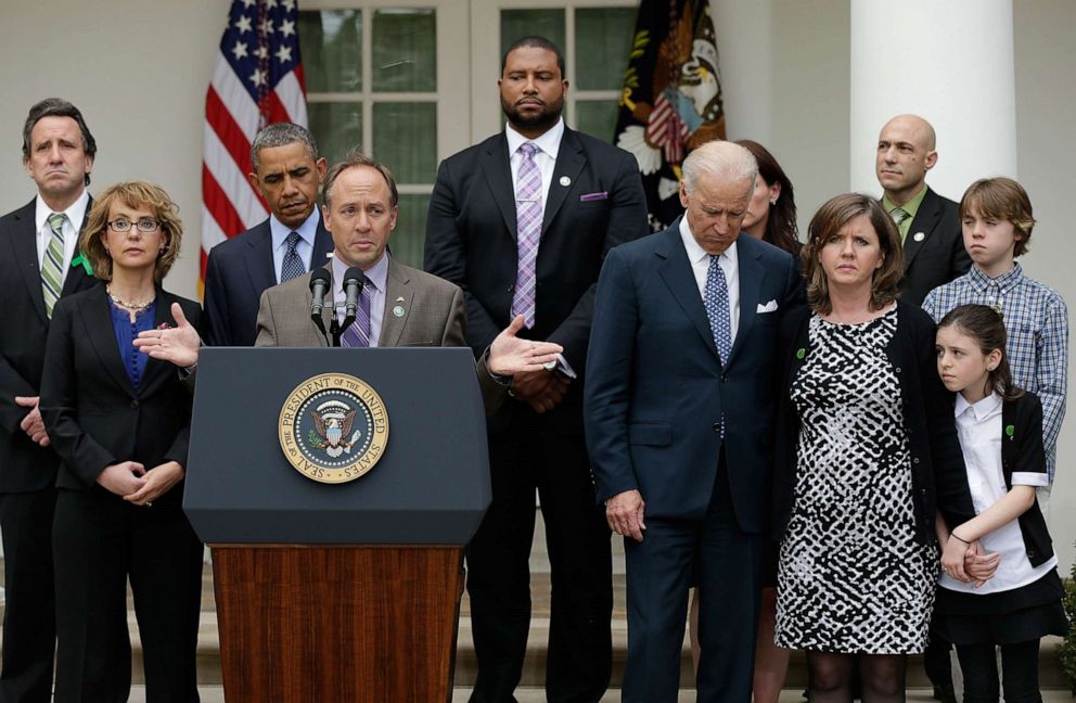 PHOTO: Jeremy Richman, top right, listens as Mark Barden joins U.S. President Barack Obama and Vice President Joe Biden in making a statement on gun violence in the Rose Garden of the White House on April 17, 2013, in Washington.