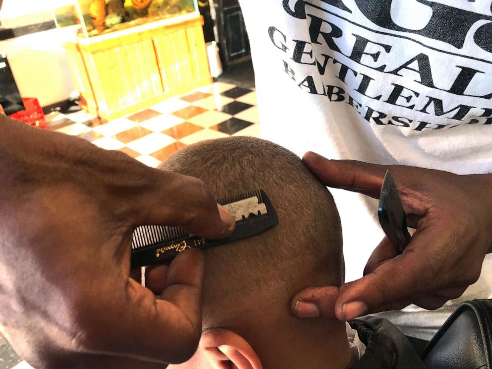 PHOTO: Jerome Morgan uses a technique that he learned while serving 20 years in Louisiana's notorious Angola prison, relying only on a razor blade and cheap plastic comb for a sharp look rather than the latest tools.