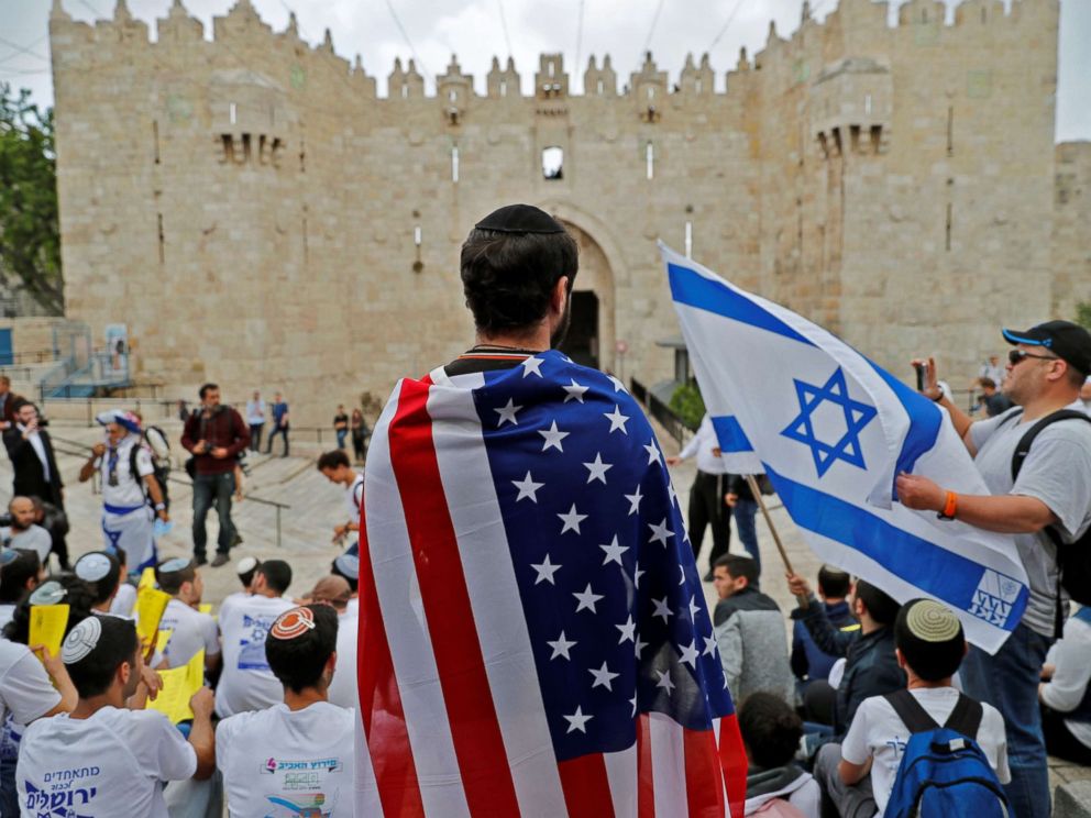 PHOTO: An Israeli man wears the US national flag at Damascus gate in Jerusalem on May 13, 2018, as Israeli nationalist settlers celebrate the Jerusalem Day in the Old City.