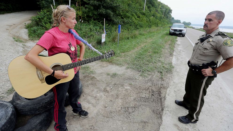 PHOTO: In this Aug. 30, 2016, file photo, activist Jessica Reznicek talks with Lee County Sheriff's Deputy Steve Sproul while conducting a personal occupation and protesting the Bakken pipeline, at a pipeline construction site, near Keokuk, Iowa.