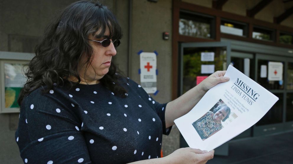 PHOTO: Jessica Tunis stands outside a Red Cross evacuation center and holds a flyer about her missing mother, Oct. 11, 2017, in Santa Rosa, Calif.
