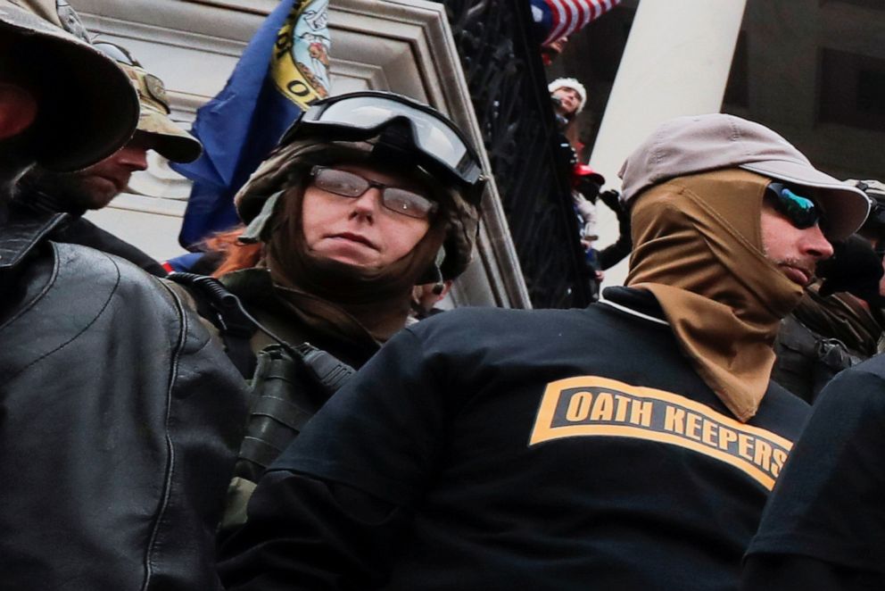 Members of the Oath Keepers militia group, including Jessica Marie Watkins, left, stand among supporters of President Donald Trump on the east front steps of the U.S. Capitol in Washington, Jan. 6, 2021.