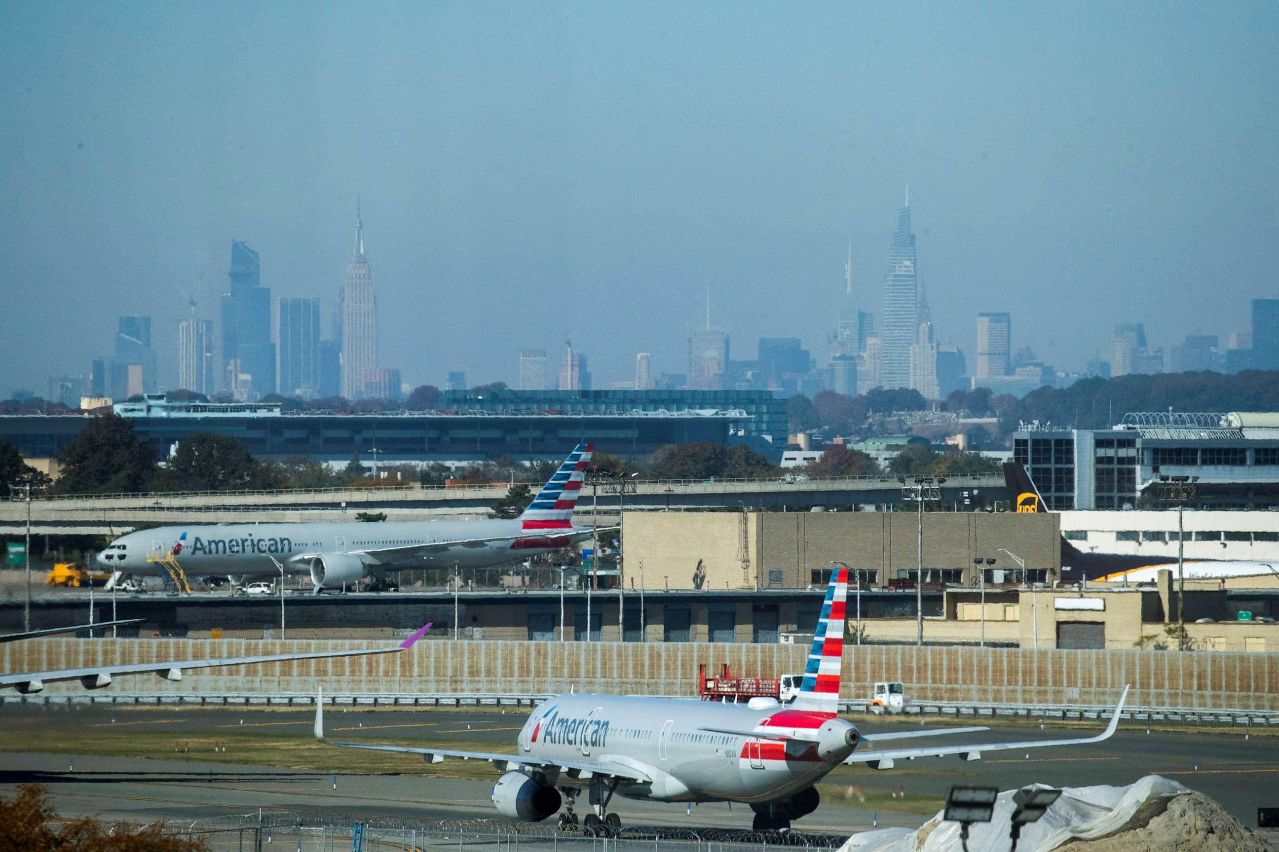 PHOTO: Planes taxi on the tarmac as the skyline of New York City is seen in the background from the JFK International Airport in New York, Nov. 8, 2021.