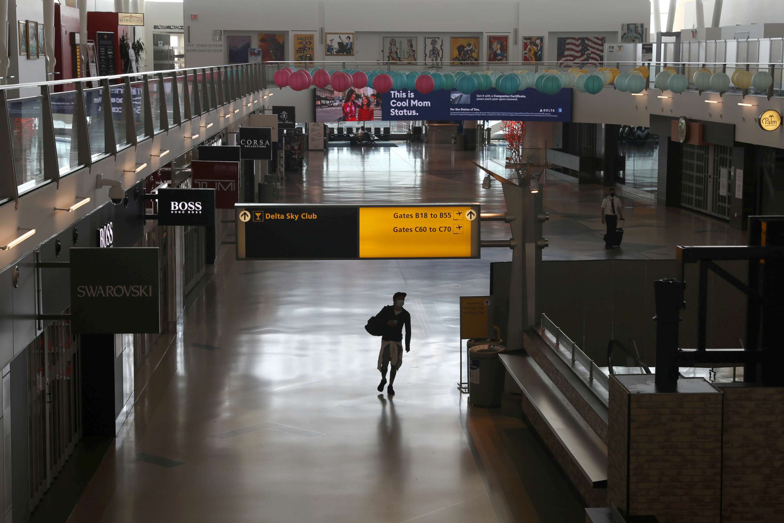 PHOTO: An air traveler walks through a terminal as the coronavirus disease (COVID-19) outbreak continues, at New York's JFK International Airport in New York, May 15, 2020.