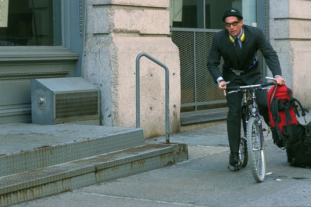 PHOTO: John F. Kennedy Jr. boards his bicycle outside his Tribecca home in New York City.