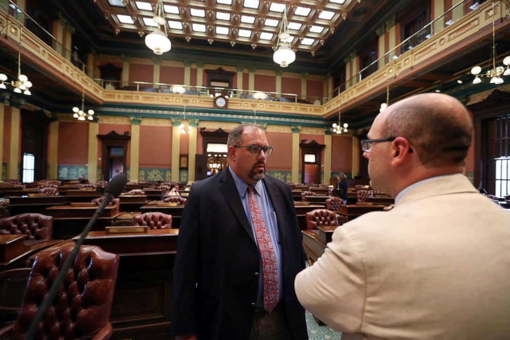 PHOTO: Michigan State Senator, Jim Ananich, Minority Leader, left, speaks on the floor of the Michigan state capital with state representative John Cherry, Aug. 27, 2019, in Lansing, Mich.