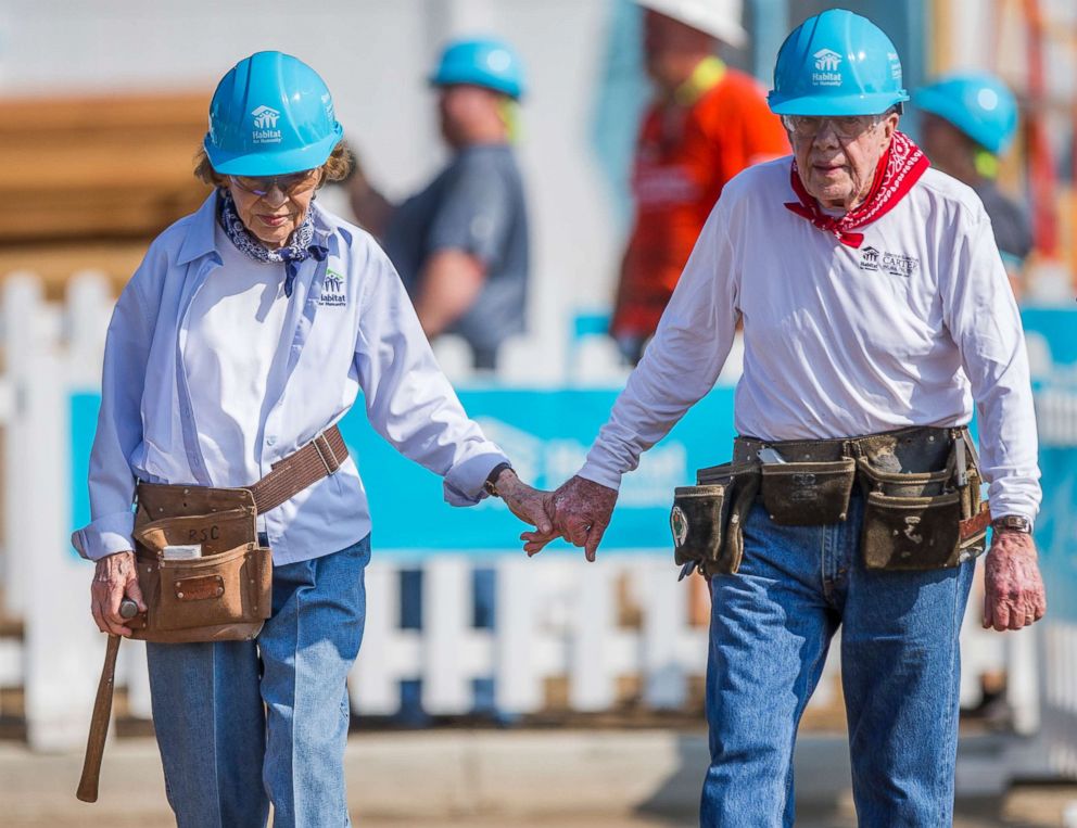 PHOTO: Former President Jimmy Carter holds hands with his wife, former first lady Rosalynn Carter, as they work with other volunteers at a work project with Habitat for Humanity, Aug. 27, 2018, in Mishawaka, Ind.