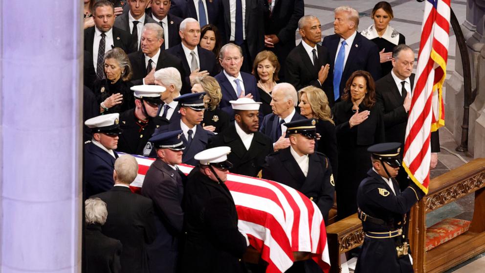 PHOTO: U.S. Military Body Bearers carry the flag-draped casket bearing the remains of former U.S. President Jimmy Carter past former Presidents into the Washington National Cathedral for his state funeral, Jan. 9, 2025, in Washington.