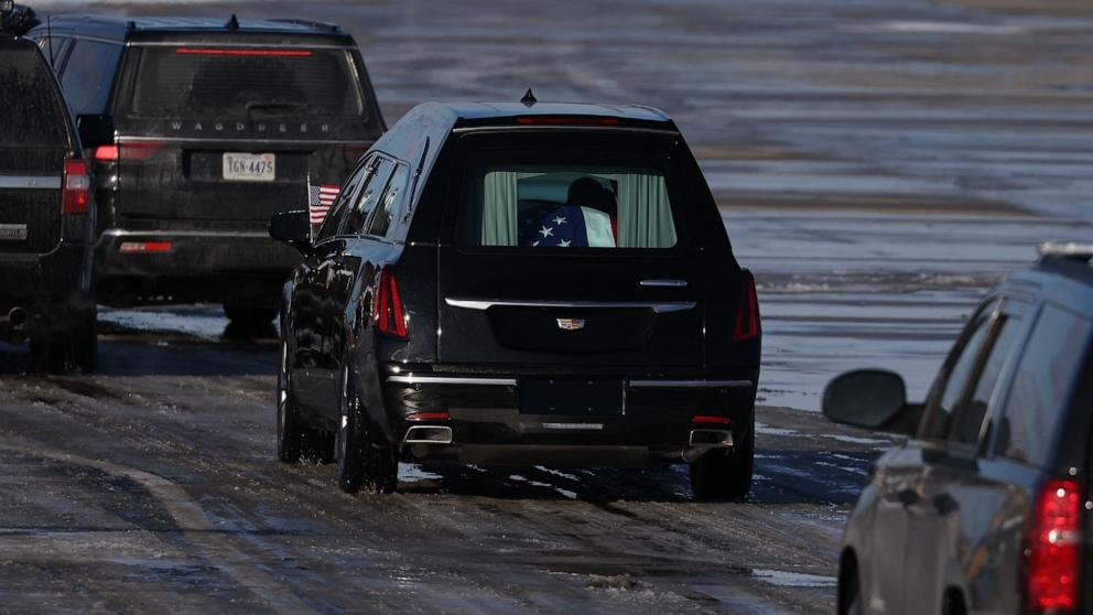 PHOTO: The flag-draped casket of former US President Jimmy Carter departs in a hearse during following an arrival ceremony in Joint Base Andrews, Maryland, Jan. 7, 2025. 