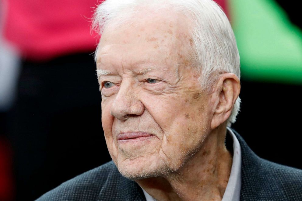 PHOTO: FILE - Former President Jimmy Carter sits on the Atlanta Falcons bench before the first half of an NFL football game between the Atlanta Falcons and the San Diego Chargers, Oct. 23, 2016, in Atlanta.