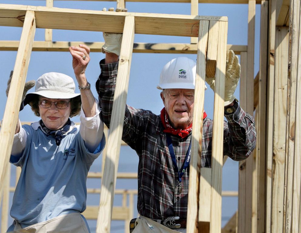 PHOTO: Former President Jimmy Carter, right, and former first lady Rosalynn Carter raise a wall as they help build a Habitat for Humanity house in Violet, La., May 21, 2007.