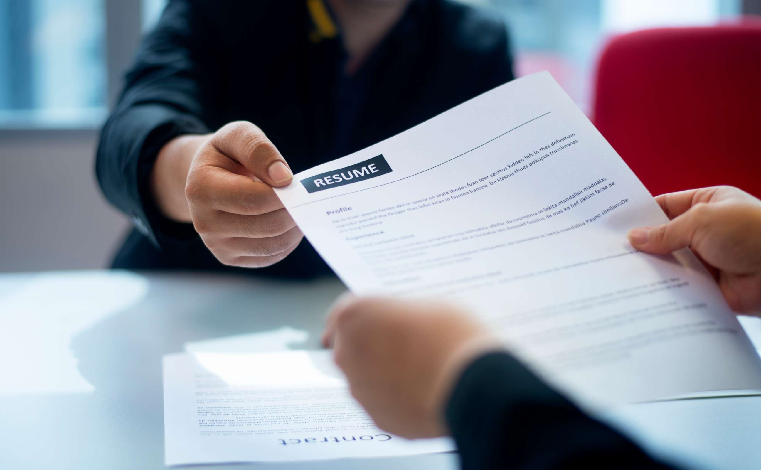 PHOTO: Stock photo of a resume being handed to an interviewer.