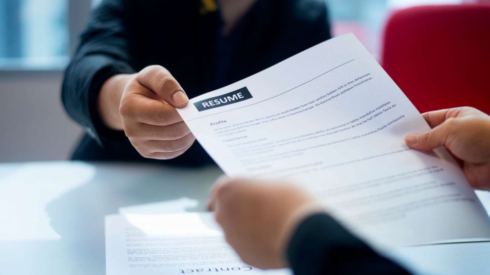 PHOTO: Stock photo of a resume being handed to an interviewer.