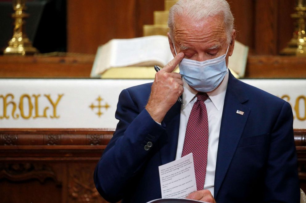 PHOTO: Democratic presidential candidate and former Vice President Joe Biden wipes his eye as an attendee talks about his late son Beau Biden during a visit to the Bethel AME Church in Wilmington, Delaware, June 1, 2020.
