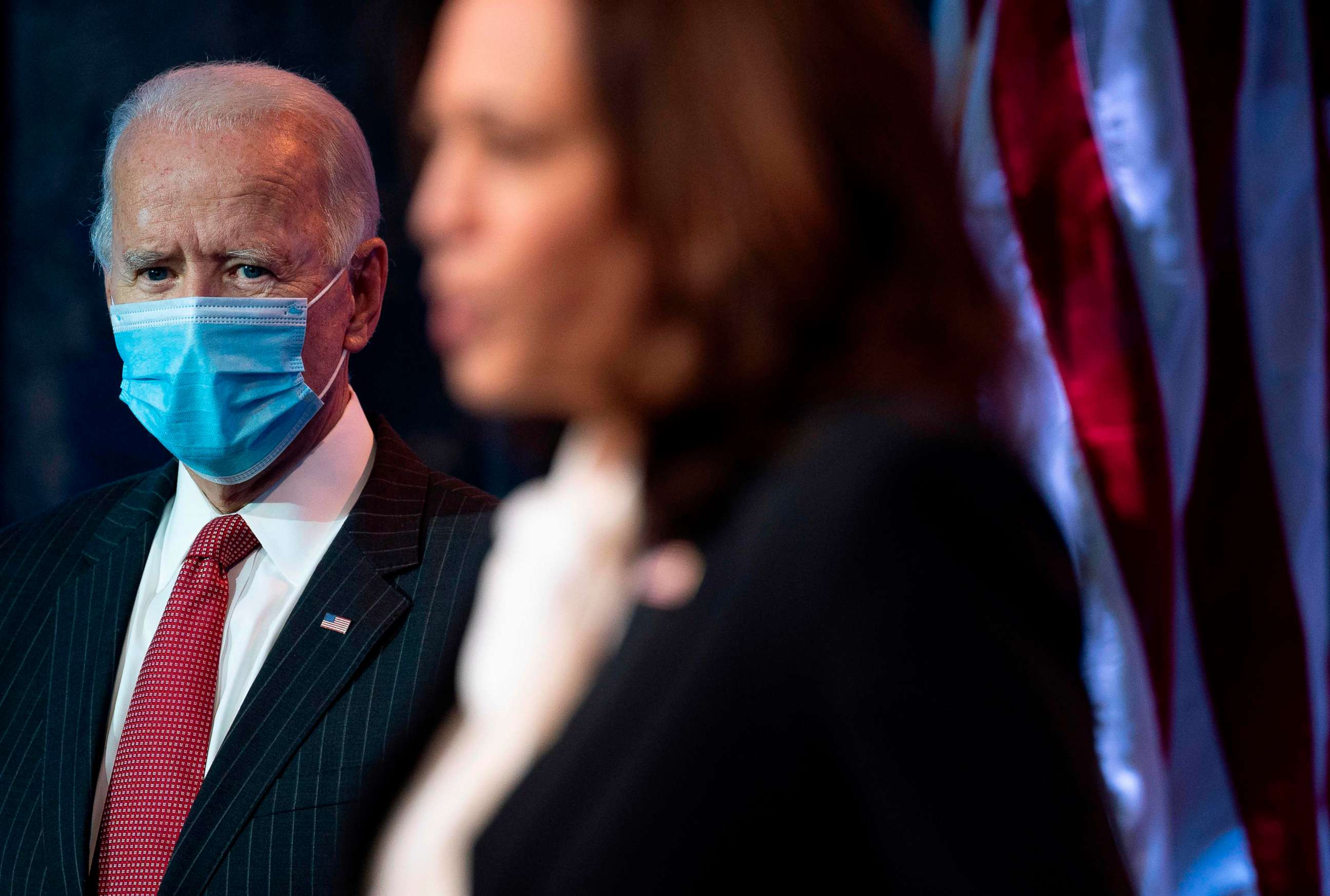 PHOTO: President-elect Joe Biden looks on as Vice president-elect Kamala Harris delivers remarks following a meeting with the Governors and Covid team on Nov. 19, 2020 in Wilmington, Del.