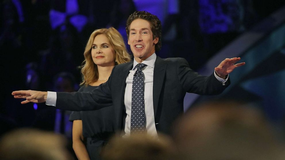 PHOTO: Joel Osteen, the pastor of Lakewood Church, stands with his wife, Victoria Osteen, as he conducts a service at his church, Sep. 3, 2017, in Houston.