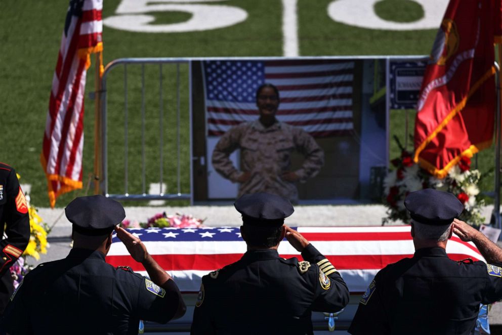PHOTO: Police officers salute the casket of Sgt. Johanny Rosario Pichardo during her public viewing at Veterans Memorial Stadium, Sept. 14, 2021, in Lawrence, Massachusetts.