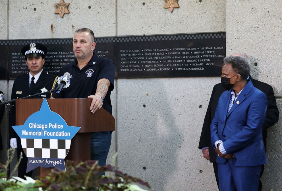 PHOTO: John Catanzara, president of the Chicago Fraternal Order of Police Lodge 7, addresses attendees as Mayor Lori Lightfoot watches during the unveiling of names for five recently deceased Chicago police officers in September 2021.