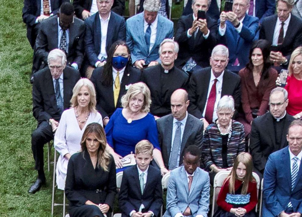 PHOTO: Rev. John Jenkins, center, the president of the University of Notre Dame, sits unmasked amidst the crowd as President Donald Trump holds an event  in the Rose Garden of the White House, Sept. 26 ,2020.