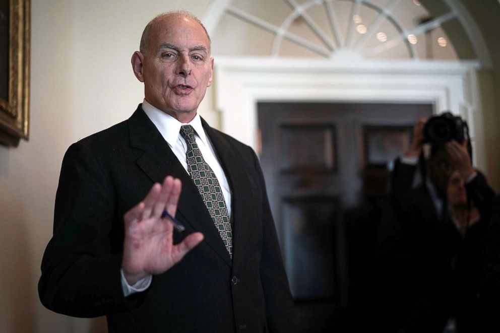 PHOTO: White House Chief of Staff John Kelly signals photographers to stop from taking pictures of him during a meeting between President Donald Trump and congressional members in the Cabinet Room of the White House on Feb. 13, 2018.