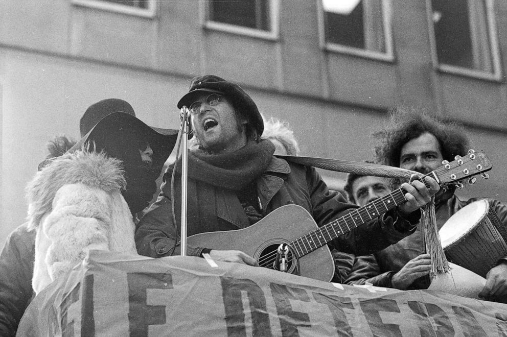 PHOTO: Former Beatle John Lennon and his wife Yoko Ono sing during a demonstration by about 500 in front of British Overseas Airways Corp. offices on Fifth Avenue in New York, Feb. 5, 1972.