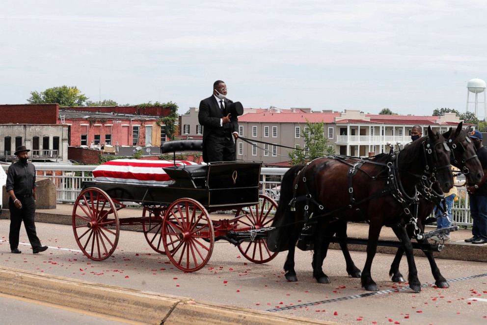 PHOTO: The casket of Rep. John Lewis moves over the Edmund Pettus Bridge by horse drawn carriage during a memorial service for Lewis, July 26, 2020, in Selma, Ala.