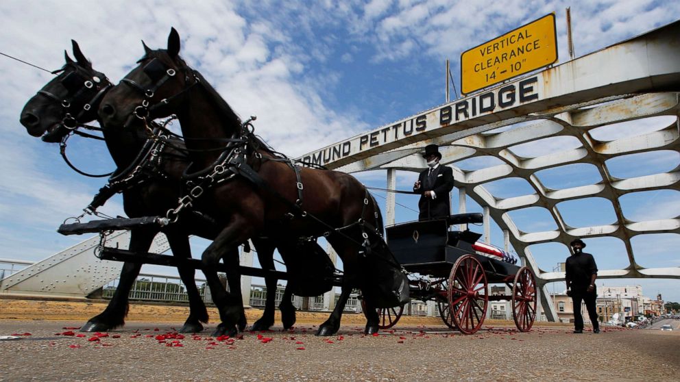 Hundreds of mourners watched the procession escorting the congressman's casket across the 1,284-foot bridge. 