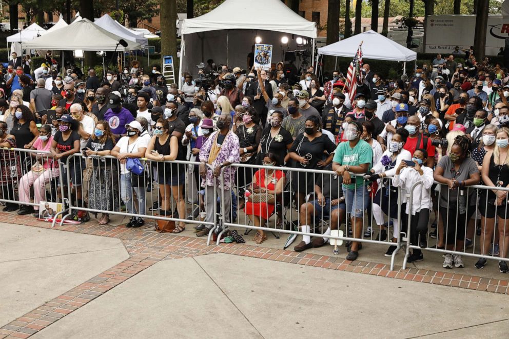 PHOTO: People watch on a large screen outside the Celebration of Life Service for civil rights leader and Democratic Rep. from John Lewis at Ebenezer Baptist Church in Atlanta, July 30, 2020.