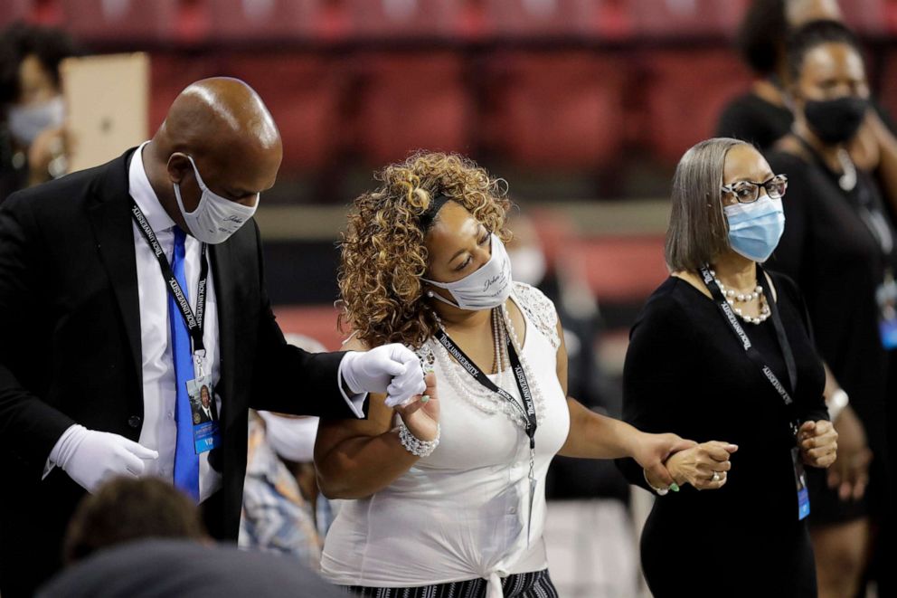 PHOTO: Mourners sing during the service for the late Rep. John Lewis at Troy University on July 25, 2020, in Troy, Ala.