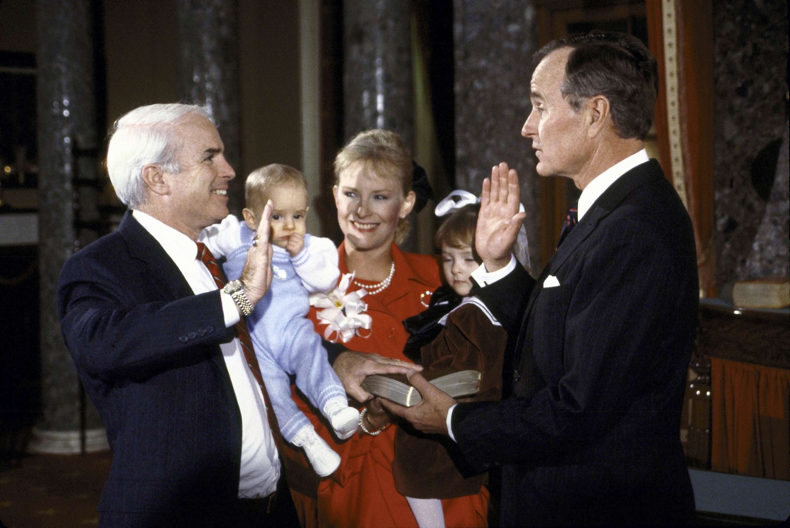 PHOTO: Vice President George H.W. Bush re-enacts the swearing in of Sen. John McCain with his wife Cindy and children Jack and Meghan in January 1987.