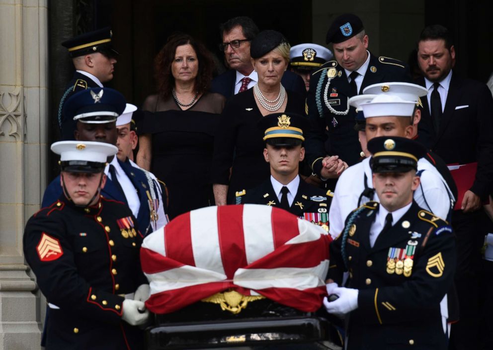 PHOTO: The casket of Sen. John McCain is carried out of the Washington National Cathedral in Washington, Sept. 1, 2018, after a memorial service, as Cindy McCain is escorted by her son Jimmy McCain and other family members.