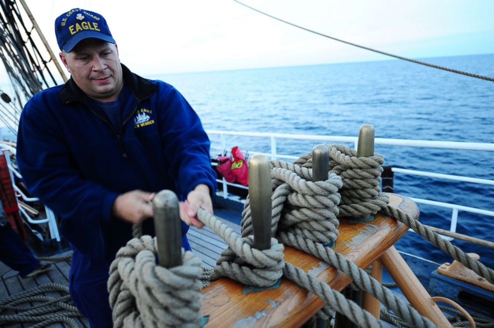 PHOTO: U.S. Coast Guard Barque Eagle crewman Petty Officer 1st Class John Presnar handles a line while adjusting sails aboard the Eagle Sept. 17, 2012.