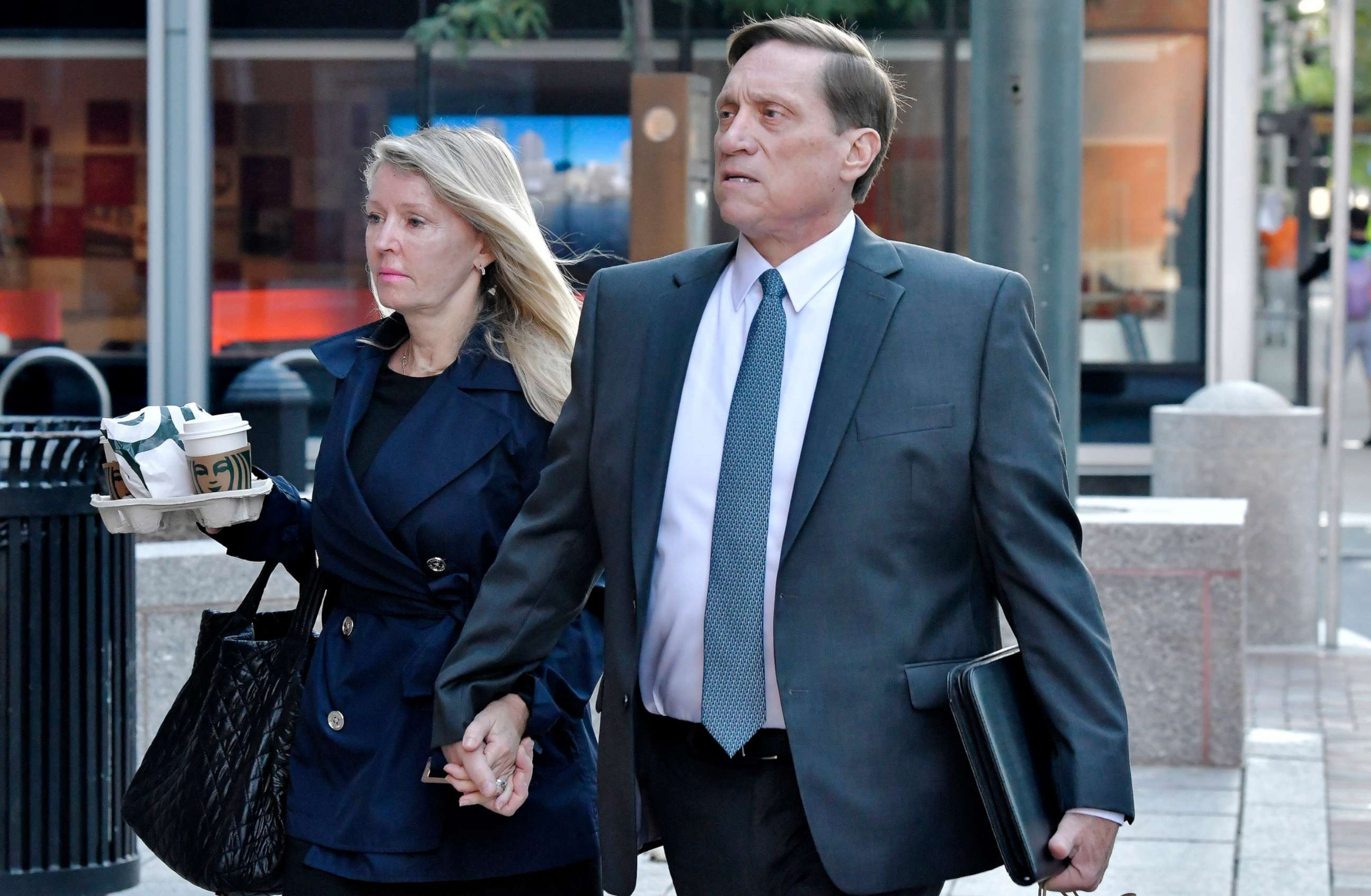 PHOTO: John Wilson and his wife arrive at federal court, Oct. 7, 2021, in Boston. Lawyers gave closing arguments in the case against Gamal Abdelaziz and John Wilson, who are accused of paying bribes to get their kids into college.